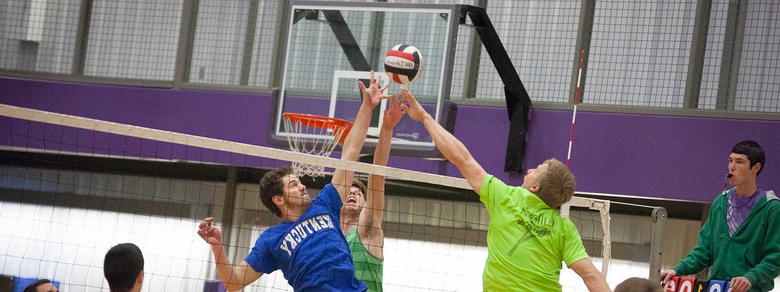 students playing volleyball in intramural gym